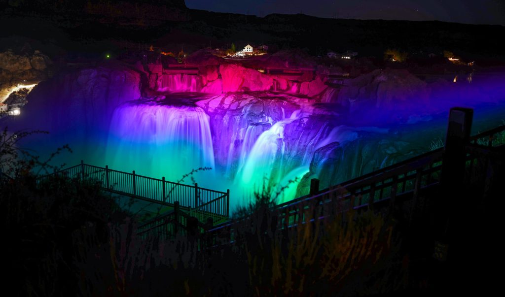 Shoshone Falls being illuminated with colorful lights during the Shoshone Falls After Dark event.