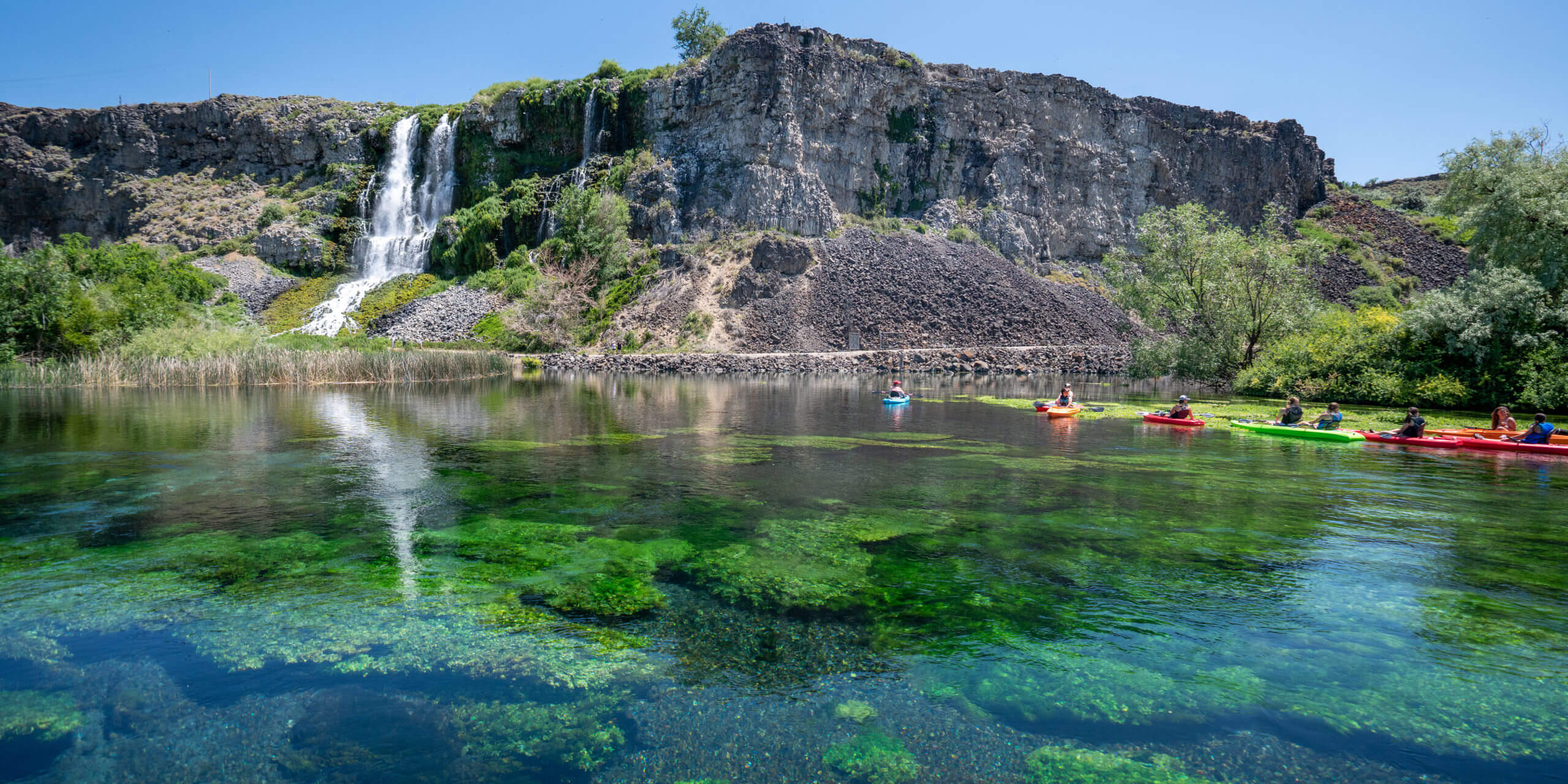 A group of kayakers in a row enjoying Blue Heart Springs.