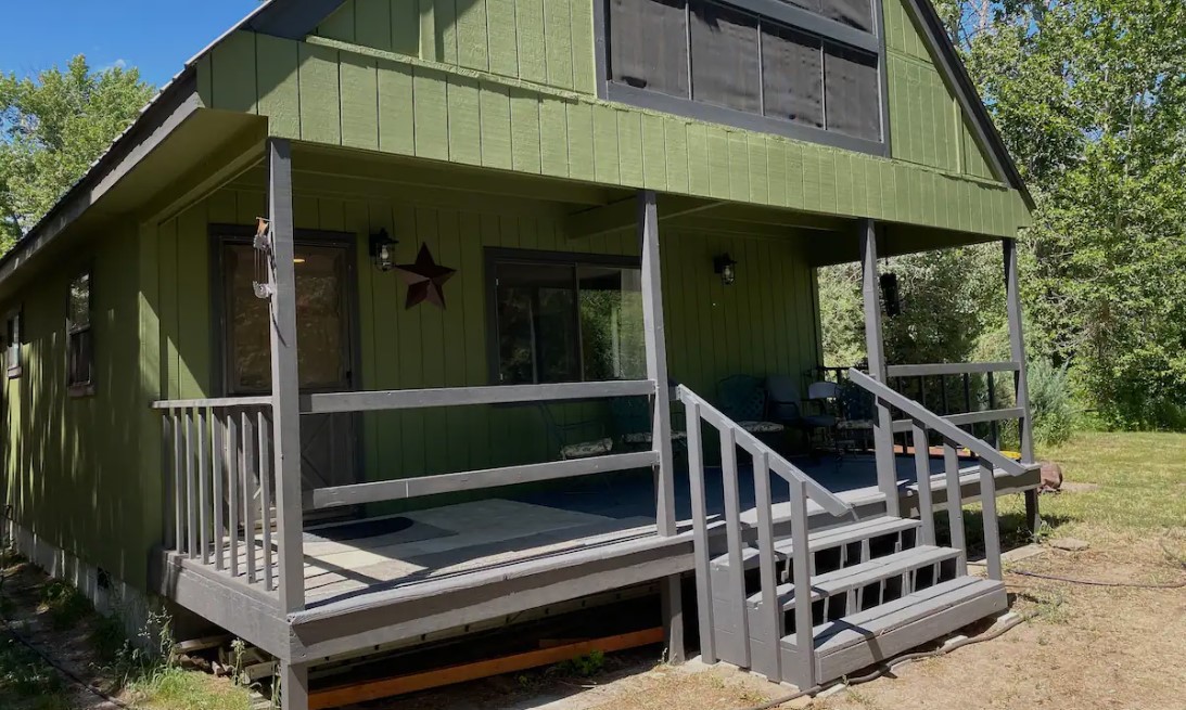 The green exterior of Creekside Cottage.