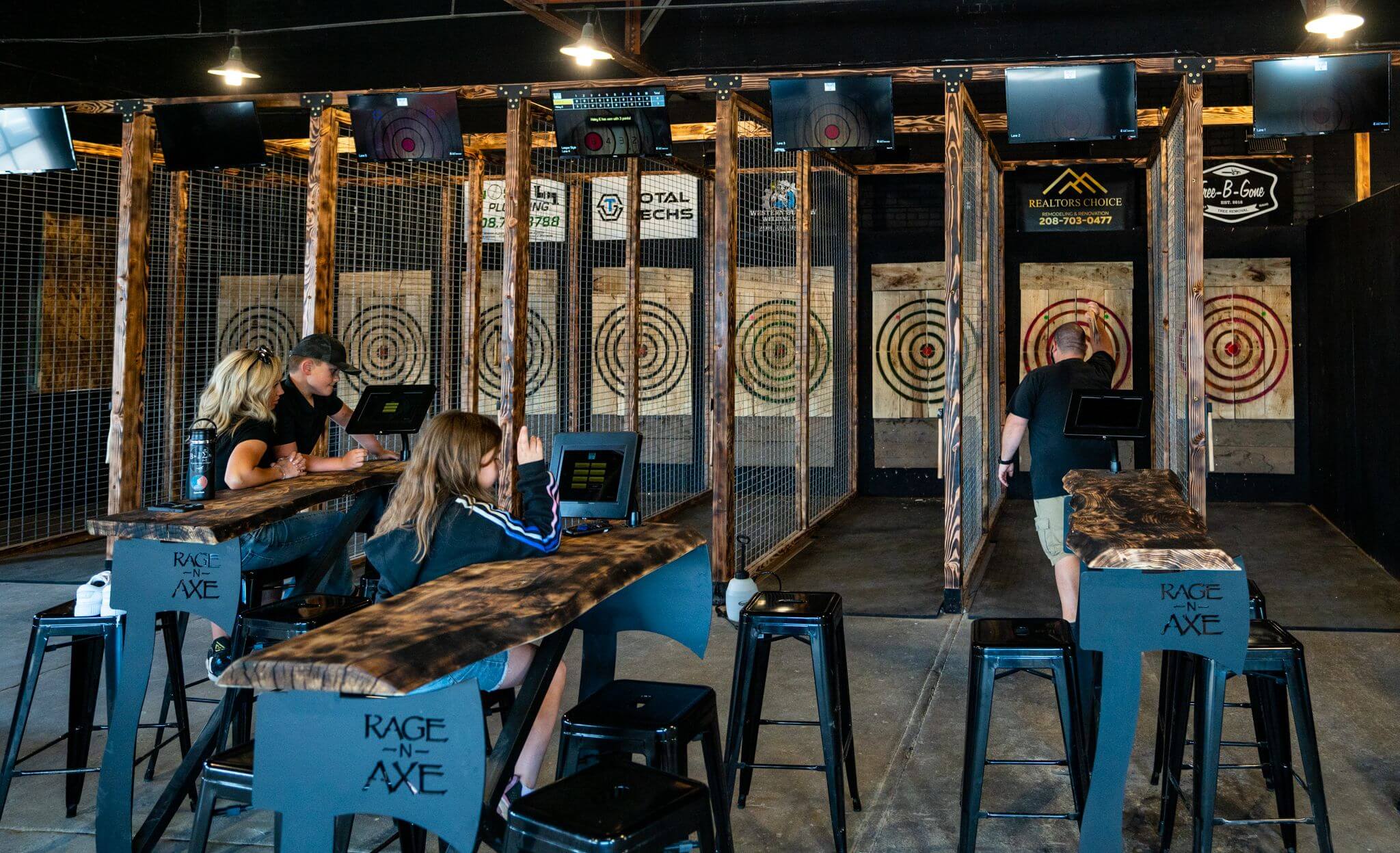 Two parties of two people each enjoying the Twin Blades Axe Throwing facilities.