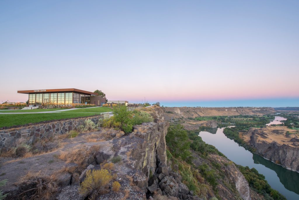 A scenic shot of the Twin Falls Visitor Center and the Snake River Canyon at sunset.