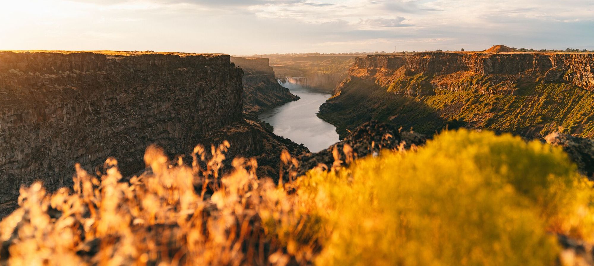 Golden fall foliage, rugged mountains, and river.