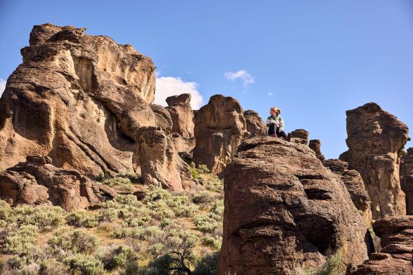 A hiker sits atop a rock formation at the City of Rocks National Reserve in Almo, Idaho.