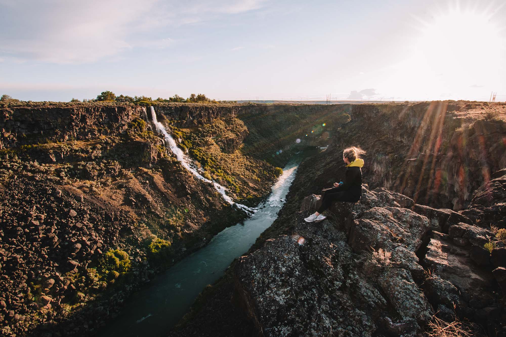 A woman watches the sunset at an overlook at Malad Gorge State Park. 